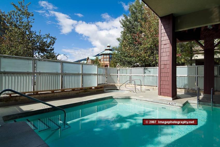 Outdoor pool and hot tub at the Tyndall Stone Lodge