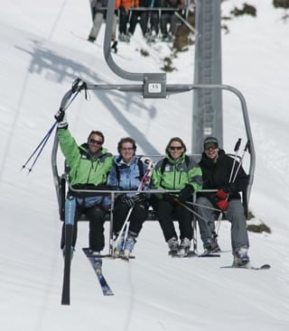 Ski club members on a chair lift